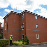 Single operator using a 35ft 10m five storey camera pole system for roof inspection, made by Vantage Point Products