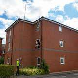 Safe, rigid and portable carbon fibre camera roof, solar and building survey and inspection pole by Vantage Point Products, 3 storey building.